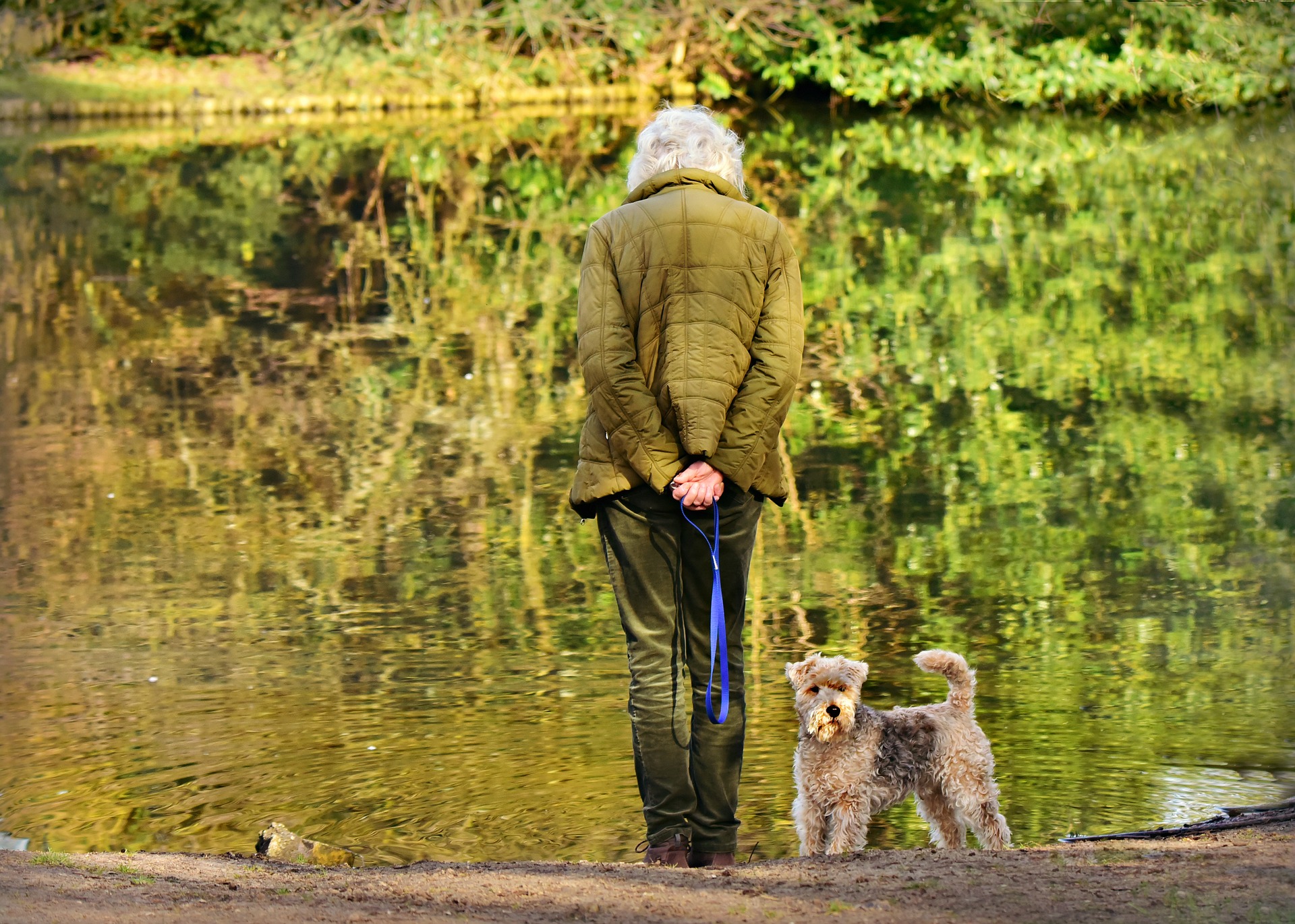 Woman with dog at pond